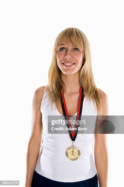 a woman wearing a gold medal and smiling - cas awards stock pictures, royalty-free photos & images