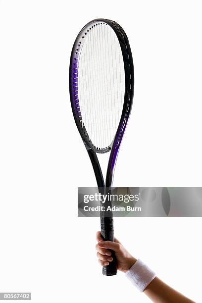 a human arm holding a tennis racket up - tennis racquet 個照片及圖片檔