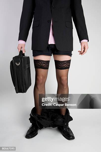 a businessman with his trousers around his ankles and wearing stockings - trousers down stock pictures, royalty-free photos & images