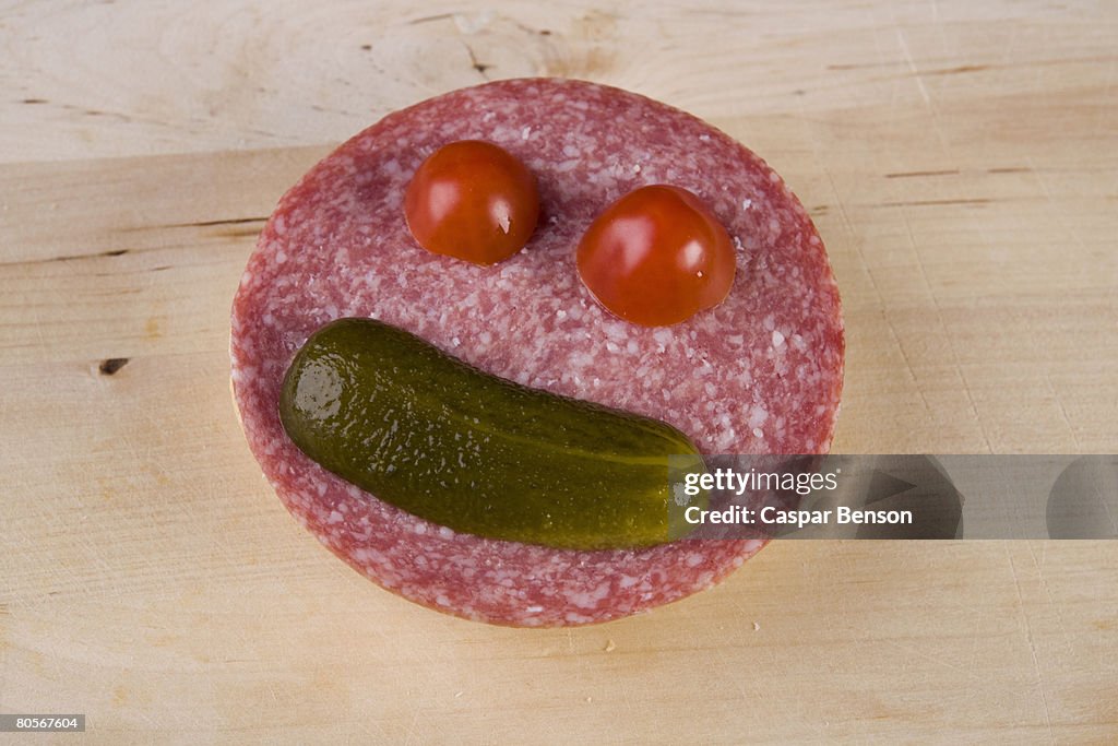 An anthropomorphic face on a slice of salami
