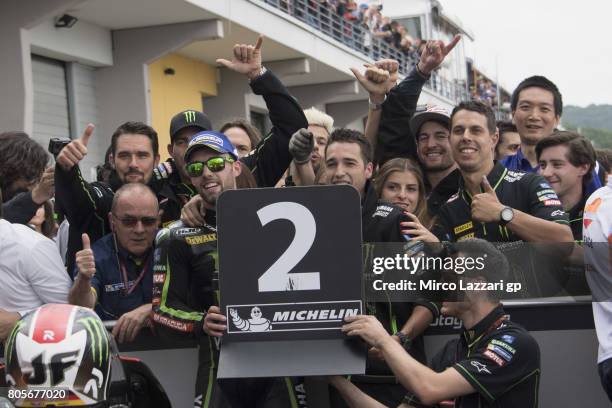 Jonas Folger of Germany and Monster Yamaha Tech 3 celebrates the second place with team under the podium at the end of the MotoGP race during the...