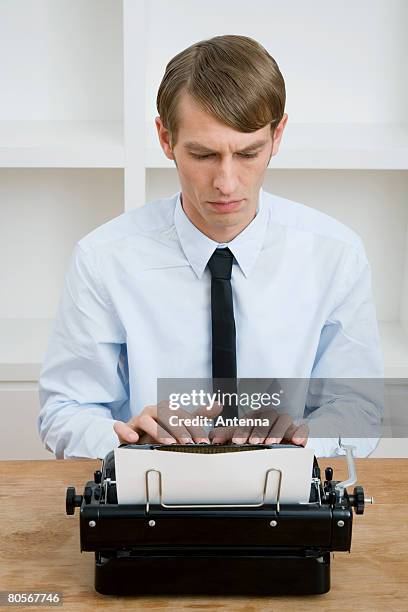 a man using a typewriter - side part stock pictures, royalty-free photos & images
