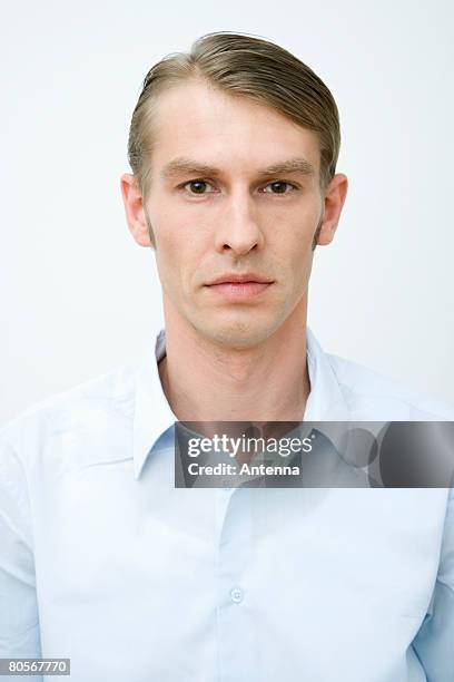 portrait of a man in a blue shirt - slick back hair men imagens e fotografias de stock
