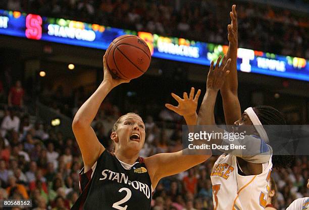 Jayne Appel of the Stanford Cardinal drives for a shot attempt against Alberta Auguste of the Tennessee Lady Volunteers during the National...