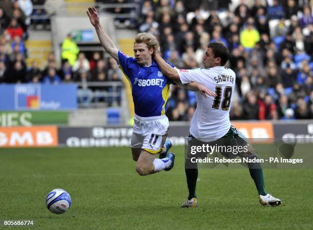 Cardiff City's Chris Burke and Plymouth Argyle's Gary Sawyer during the Coca-Cola Football League Championship match at Cardiff City Stadium, Cardiff.