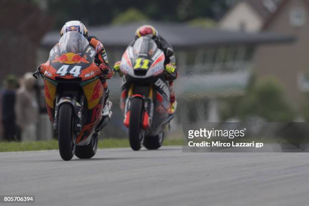 Miguel Oliveira of Portugal and Red Bull KTM Ajo leads Sandro Cortese of Germany and Dynavolt Intact GP during the Moto2 race during the MotoGp of...