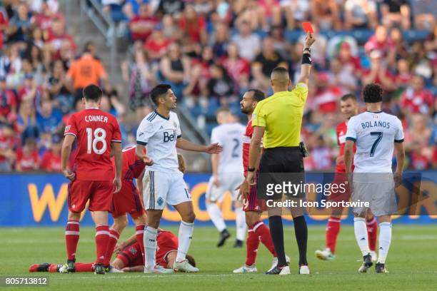 Vancouver Whitecaps FC midfielder Matias Laba receives a red card after fouling Chicago Fire forward Luis Solignac in the second half during an MLS...
