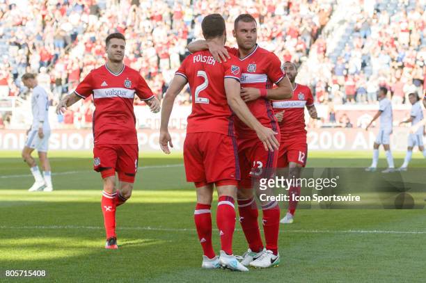 Chicago Fire forward Nemanja Nikolic celebrates his first goal with Chicago Fire defender Matt Polster in the first half during an MLS soccer match...