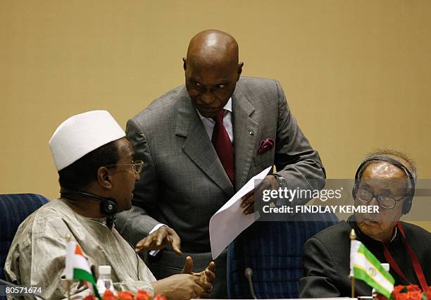 Senegalese President Maitre Abdoulaye Wade gestures as he speaks with Chairperson of the African Union Commission Alpha Oumar Konare as Indian...