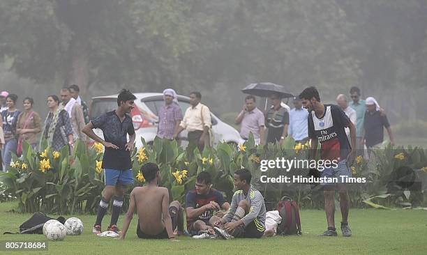 People enjoy Monsoon rain in Sunday morning on July 2, 2017 in New Delhi, India. The southwest monsoon finally hit Delhi and the National Capital...