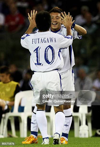 Takahiro Futagawa of Gamba Osaka is congratulated by Michihiro Yasuda after scoring during the AFC Champions League Group G match between the...