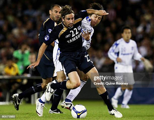 Nick Ward of the Victory and Yasuhito Endo of Osaka contest the ball during the AFC Champions League Group G match between the Melbourne Victory and...