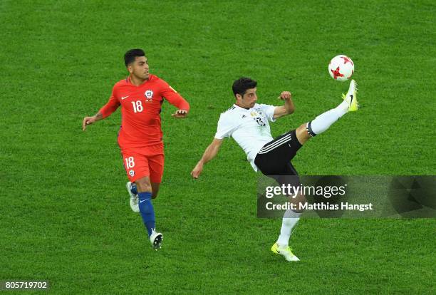 Lars Stindl of Germany clears the ball while under pressure from Gonzalo Jara of Chile during the FIFA Confederations Cup Russia 2017 Final between...