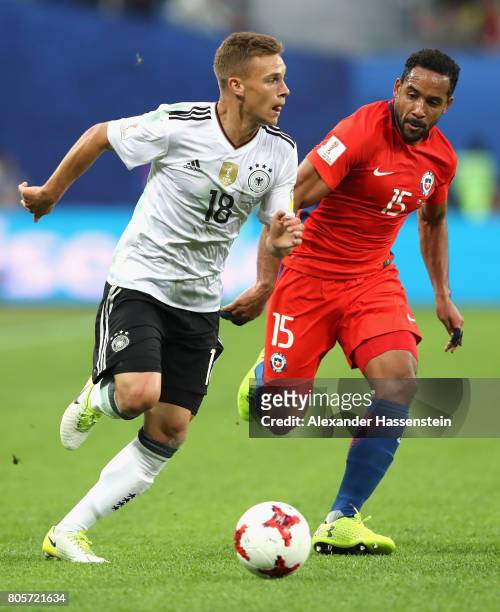 Joshua Kimmich of Germany takes the ball away from Jean Beausejour of Chile during the FIFA Confederations Cup Russia 2017 Final between Chile and...