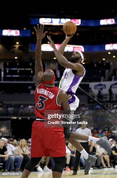 Al Harrington of Trilogy defends against Hakim Warrick of the 3 Headed Monsters during week two of the BIG3 three on three basketball league at...