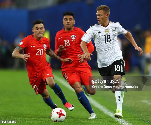 Joshua Kimmich of Germany attemtps to take the ball away from Charles Aranguiz of Chile and Gonzalo Jara of Chile during the FIFA Confederations Cup...