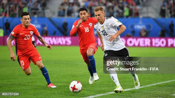 Joshua Kimmich of Germany attempts to take the ball away from Charles Aranguiz of Chile and Gonzalo Jara of Chile during the FIFA Confederations Cup...