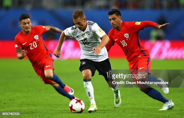 Joshua Kimmich of Germany attempts to take the ball away from Charles Aranguiz of Chile and Gonzalo Jara of Chile during the FIFA Confederations Cup...
