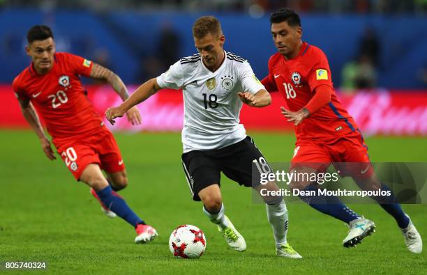 Joshua Kimmich of Germany attempts to take the ball away from Charles Aranguiz of Chile and Gonzalo Jara of Chile during the FIFA Confederations Cup...
