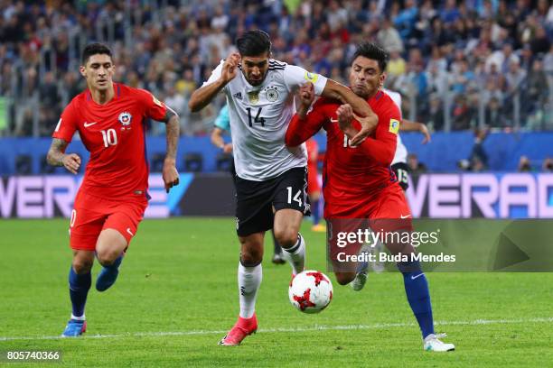 Emre Can of Germany and Gonzalo Jara of Chile battle for possession during the FIFA Confederations Cup Russia 2017 Final between Chile and Germany at...