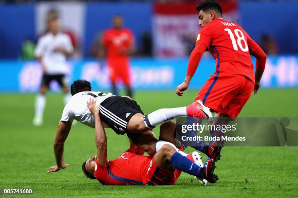 Gonzalo Jara of Chile and Gary Medel of Chile fouls Emre Can of Germany legs during the FIFA Confederations Cup Russia 2017 Final between Chile and...