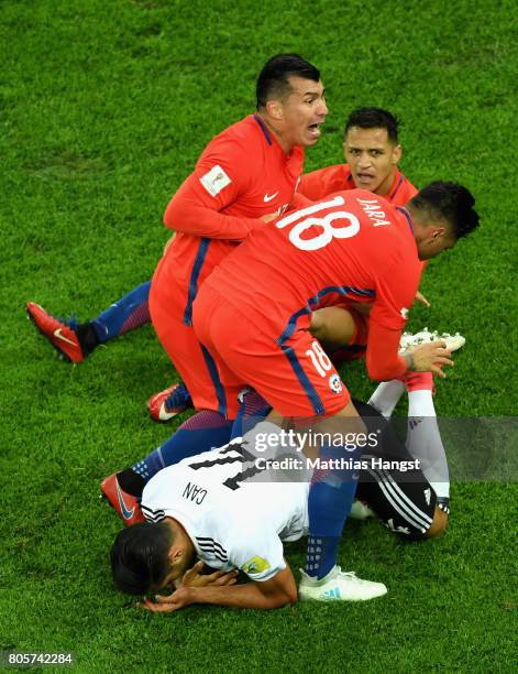 Gonzalo Jara of Chile and Gary Medel of Chile attempt to grab the ball from Emre Can of Germany legs during the FIFA Confederations Cup Russia 2017...