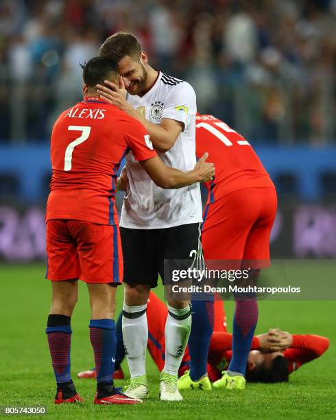 Shkodran Mustafi of Germany and Alexis Sanchez of Chile embrace after the FIFA Confederations Cup Russia 2017 Final between Chile and Germany at...