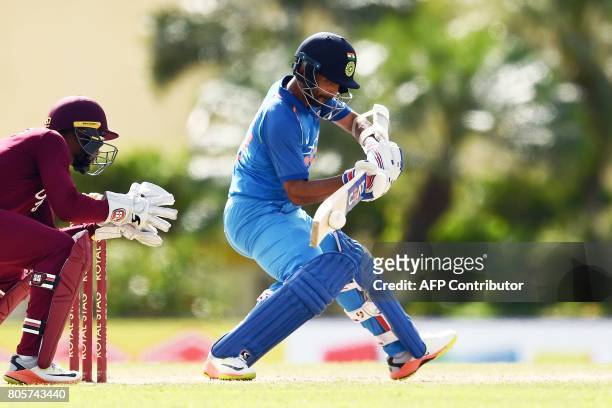 India's Ajinkya Rahane plays a shot as West Indies' wicketkeeper Shai Hope looks on during the fourth One Day International match between West Indies...