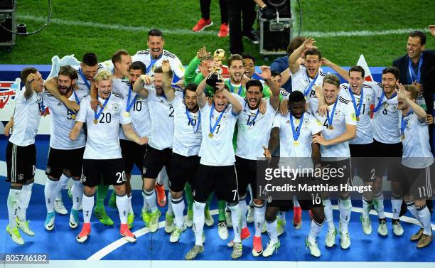 Julian Draxler of Germany lifts the FIFA Confederations Cup trophy after the FIFA Confederations Cup Russia 2017 Final between Chile and Germany at...