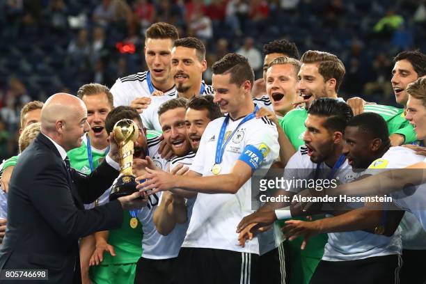 Gianni Infantino, FIFA president hands Julian Draxler of Germany the trophy after the FIFA Confederations Cup Russia 2017 Final between Chile and...