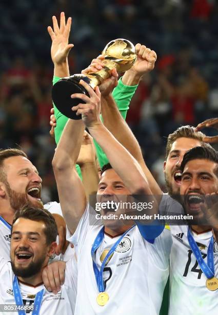 Julian Draxler of Germany lifts the FIFA Confederations Cup trophy after the FIFA Confederations Cup Russia 2017 Final between Chile and Germany at...