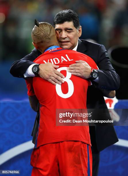 Arturo Vidal of Chile and Diego Maradona embrace after the FIFA Confederations Cup Russia 2017 Final between Chile and Germany at Saint Petersburg...