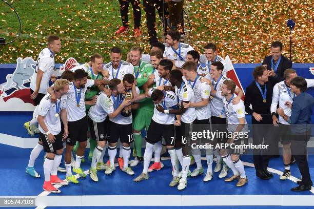 Germany's players pose with the trophy after winning the 2017 Confederations Cup final football match between Chile and Germany at the Saint...