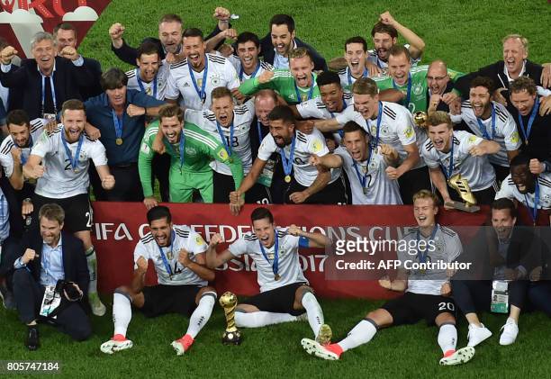 Germany's players pose with the trophy after winning the 2017 Confederations Cup final football match between Chile and Germany at the Saint...