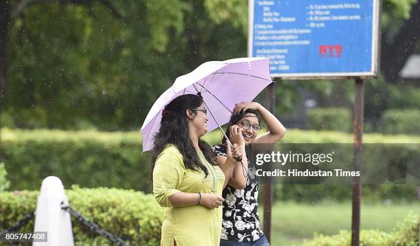 People enjoy Monsoon rain on Sunday morning on July 2, 2017 in New Delhi, India. The southwest monsoon finally hit Delhi and the National Capital...