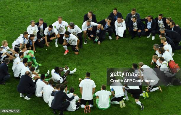 Germany's players pose with the trophy after winning the 2017 Confederations Cup final football match between Chile and Germany at the Saint...