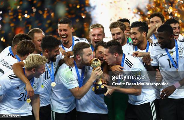 Shkodran Mustafi of Germany and Julian Draxler of Germany kiss the trophy after the FIFA Confederations Cup Russia 2017 Final between Chile and...