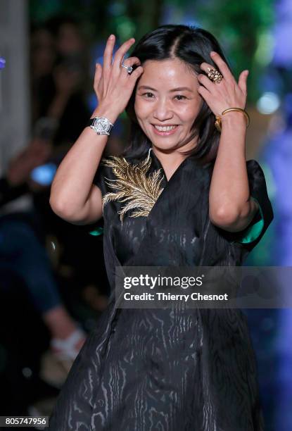 Chinese designer Guo Pei acknowledges the audience at the end of the Guo Pei Haute Couture Fall/Winter 2017-2018 show as part of Haute Couture Paris...