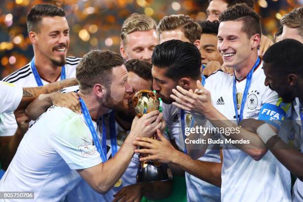 Shkodran Mustafi of Germany and Julian Draxler of Germany kiss the trophy after the FIFA Confederations Cup Russia 2017 Final between Chile and...