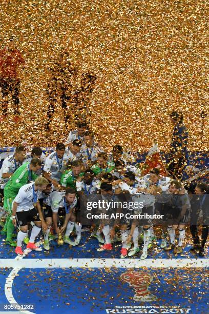 Germany's players pose with the trophy after winning the 2017 Confederations Cup final football match between Chile and Germany at the Saint...