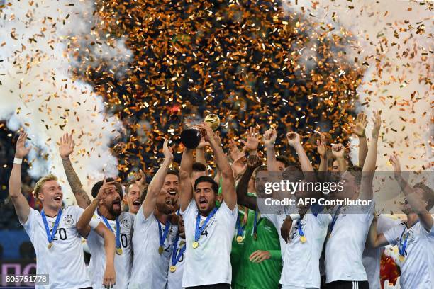 Germany's players pose with the trophy after winning the 2017 Confederations Cup final football match between Chile and Germany at the Saint...