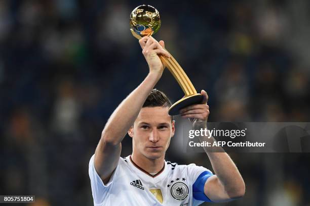Germany's midfielder Julian Draxler holds the Golden Ball trophy after Germany beat Chile 1-0 in the 2017 Confederations Cup final football match...
