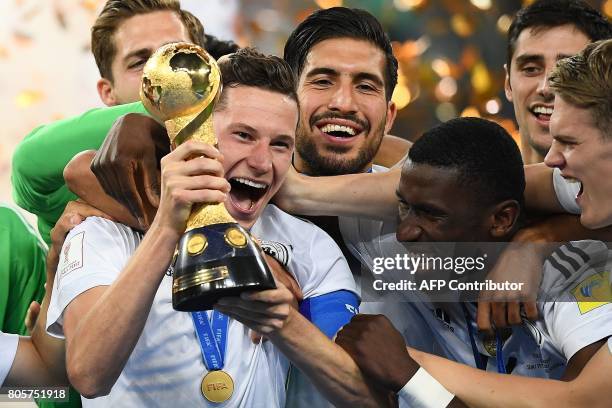 Germany's midfielder Julian Draxler lifts the trophy after winning the 2017 Confederations Cup final football match between Chile and Germany at the...