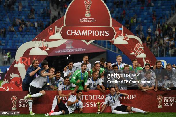 Germany's players pose with the trophy after winning the 2017 Confederations Cup final football match between Chile and Germany at the Saint...