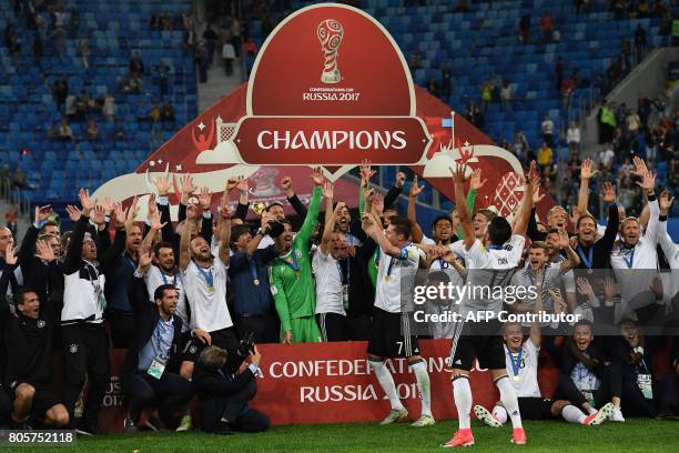 Germany's players pose with the trophy after winning the 2017 Confederations Cup final football match between Chile and Germany at the Saint...