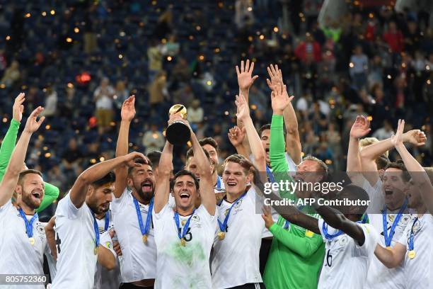 Germany's midfielder Lars Stindl lifts the trophy after winning the 2017 Confederations Cup final football match between Chile and Germany at the...
