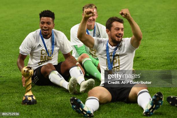 Germany's players pose with the trophy after winning the 2017 Confederations Cup final football match between Chile and Germany at the Saint...