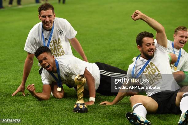 Germany's players pose with the trophy after winning the 2017 Confederations Cup final football match between Chile and Germany at the Saint...