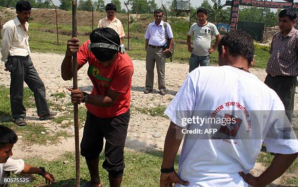 Nepalese election officials prepare the site for polling in the general election at the entry point of the Headquarters of the First Division of the...