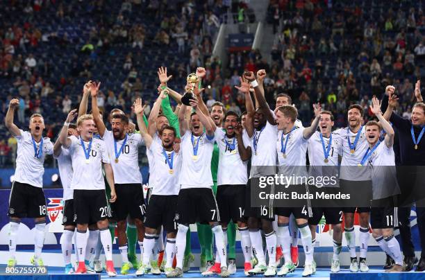 Julian Draxler of Germany lifts the FIFA Confederations Cup trophy after the FIFA Confederations Cup Russia 2017 Final between Chile and Germany at...